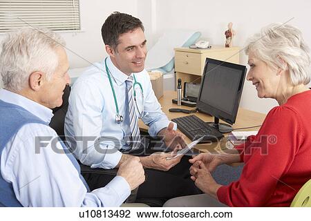 British GP talking to senior couple in surgery View Large Photo Image Stock Image - British GP talking to senior couple in surgery. Fotosearch