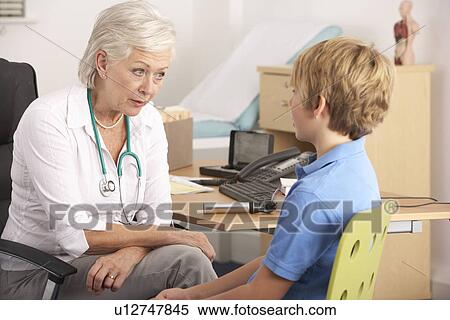 British GP talking to young boy patient View Large Photo Image Stock Photography - British GP talking to young boy patient. Fotosearch