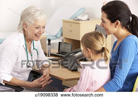 Stock Photo - British GP talking to young child and mother. Fotosearch