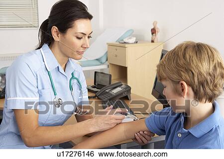 Stock Photograph - British nurse giving injection to child. Fotosearch