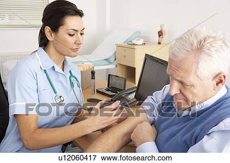 Stock Photo - British nurse giving injection to senior man. Fotosearch