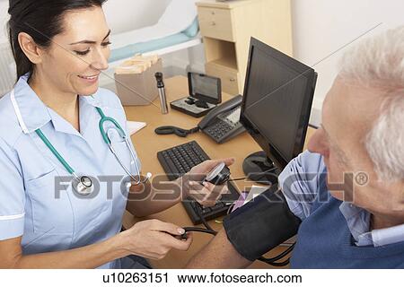 British nurse taking senior man's blood pressure View Large Photo Image Stock Image - British nurse taking senior man's blood pressure. Fotosearch