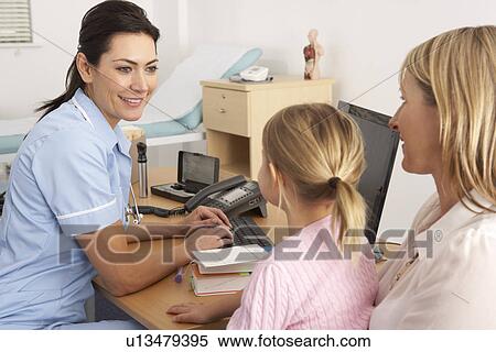 Stock Photography - British nurse talking to young child and mother. Fotosearch