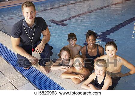 Stock Image - Children having swimming lesson. Fotosearch