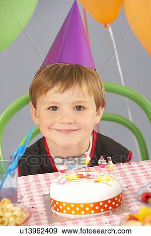 Stock Photo - Children playing pass the parcel at birthday party. Fotosearch