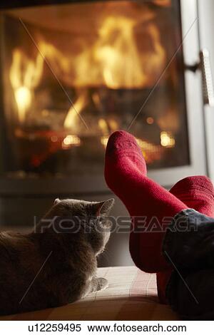 Close Up Of Mans Feet Relaxing By Cosy Log Fire With Cat View Large Photo Image Stock Photography - Close Up Of Mans Feet Relaxing By Cosy Log Fire With Cat. Fotosearch