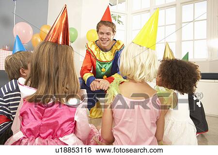 Clown entertaining children at party View Large Photo Image Stock Photograph - Clown entertaining children at party. Fotosearch