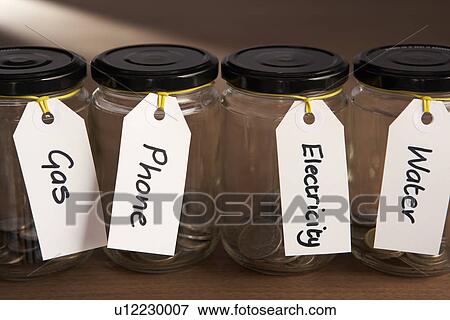 Stock Photo - Coins in a jam jar. Fotosearch