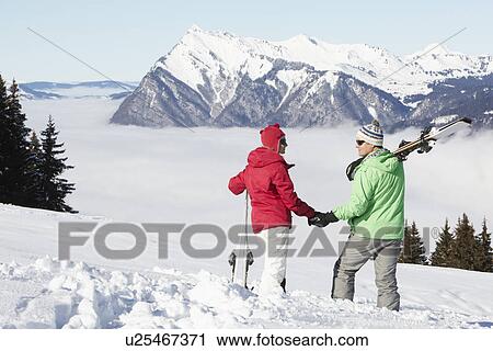 Couple Admiring Mountain View Whilst On Ski Holiday In Mountains View Large Photo Image Stock Image - Couple Admiring Mountain View Whilst On Ski Holiday In Mountains. Fotosearch