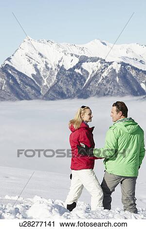 Couple Admiring Mountain View Whilst On Ski Holiday In Mountains View Large Photo Image Stock Image - Couple Admiring Mountain View Whilst On Ski Holiday In Mountains. Fotosearch