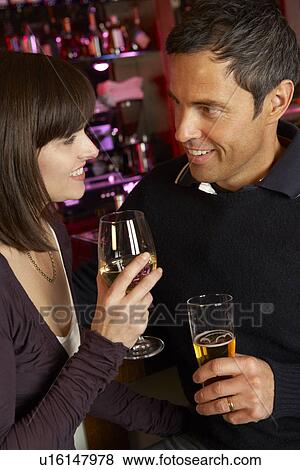 Couple Enjoying Drink Together In Bar View Large Photo Image Stock Photo - Couple Enjoying Drink Together In Bar. Fotosearch