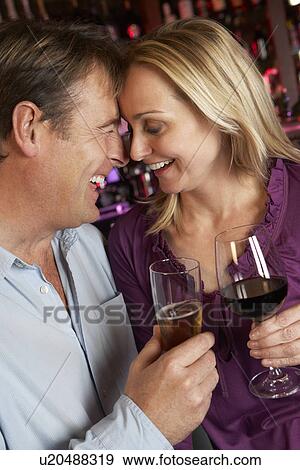 Stock Photo - Couple Enjoying Drink Together In Bar. Fotosearch
