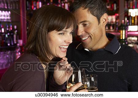 Couple Enjoying Drink Together In Bar View Large Photo Image Stock Photograph - Couple Enjoying Drink Together In Bar. Fotosearch