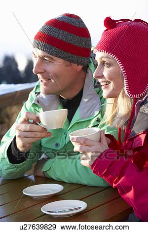 Couple Enjoying Hot Drink In Café At Ski Resort View Large Photo Image Stock Photo - Couple Enjoying Hot Drink In Café At Ski Resort. Fotosearch