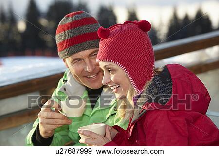 Stock Photo - Couple Enjoying Hot Drink In CafÃ© At Ski Resort. Fotosearch