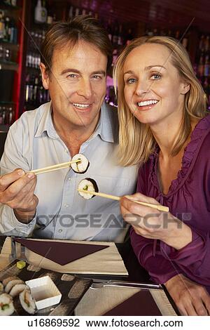 Couple Enjoying Sushi In Restaurant View Large Photo Image Stock Image - Couple Enjoying Sushi In Restaurant. Fotosearch