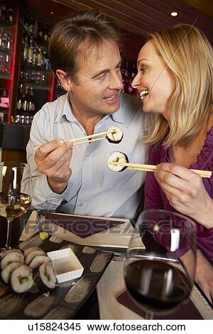 Couple Enjoying Sushi In Restaurant View Large Photo Image Stock Photography - Couple Enjoying Sushi In Restaurant. Fotosearch