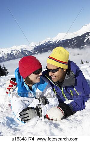 Picture - Couple Having Fun On Ski Holiday In Mountains. Fotosearch