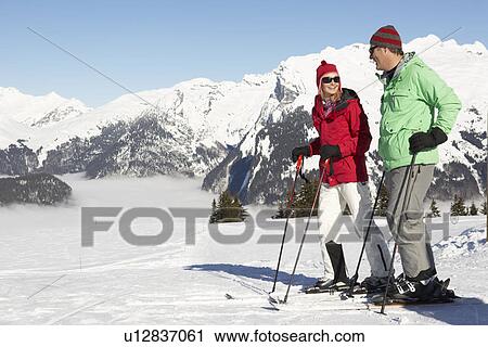 Couple Having Fun On Ski Holiday In Mountains View Large Photo Image Stock Image - Couple Having Fun On Ski Holiday In Mountains. Fotosearch