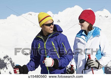 Stock Image - Couple Having Fun On Ski Holiday In Mountains. Fotosearch