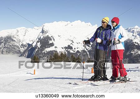 Stock Photo - Couple Having Fun On Ski Holiday In Mountains. Fotosearch