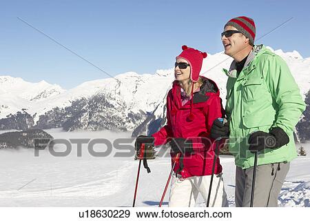 Couple Having Fun On Ski Holiday In Mountains View Large Photo Image Stock Photo - Couple Having Fun On Ski Holiday In Mountains. Fotosearch