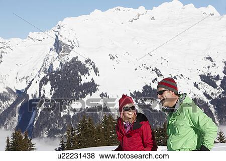 Couple Having Fun On Ski Holiday In Mountains View Large Photo Image Stock Photo - Couple Having Fun On Ski Holiday In Mountains. Fotosearch