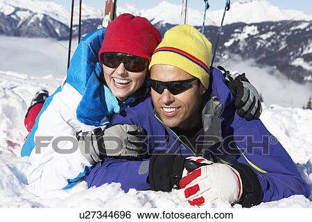 Stock Photograph - Couple Having Fun On Ski Holiday In Mountains. Fotosearch