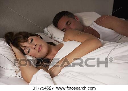 Stock Photo - Couple in bed asleep. Fotosearch