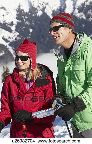 Couple Looking At Map Whilst On Ski Holiday In Mountains View Large Photo Image Picture - Couple Looking At Map Whilst On Ski Holiday In Mountains. Fotosearch