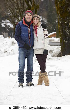 Couple Walking Along Snowy Street In Ski Resort View Large Photo Image Stock Image - Couple Walking Along Snowy Street In Ski Resort. Fotosearch