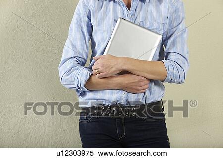 Stock Photography - Cropped Shot Of Middle Aged Woman Holding Tablet Computer. Fotosearch