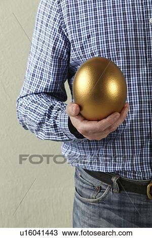 Cropped Studio Shot Of Man Holding Golden Egg View Large Photo Image Stock Image - Cropped Studio Shot Of Man Holding Golden Egg. Fotosearch