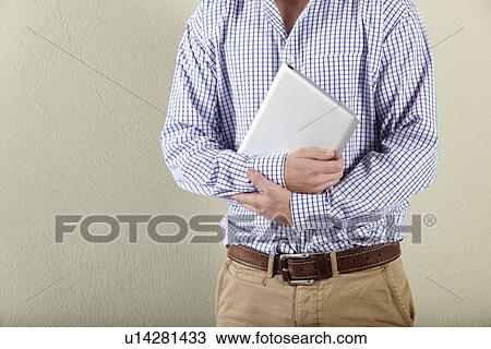 Cropped Studio Shot Of Young Man Holding Tablet Computer View Large Photo Image Stock Image - Cropped Studio Shot Of Young Man Holding Tablet Computer. Fotosearch