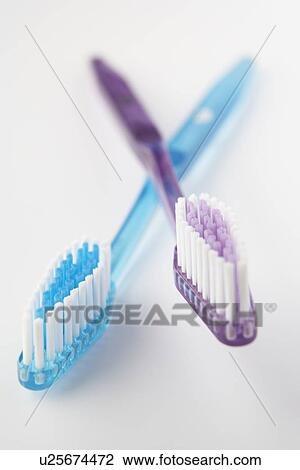 Stock Image - Crossed toothbrushes. Fotosearch