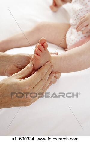 Picture - Detail baby having foot massage. Fotosearch
