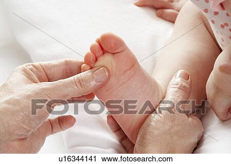 Stock Image - Detail baby having foot massage. Fotosearch