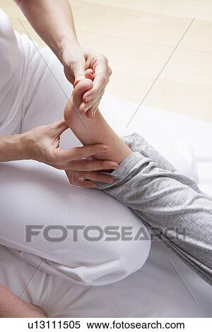 Stock Photography - Detail foot reflexology massage. Fotosearch