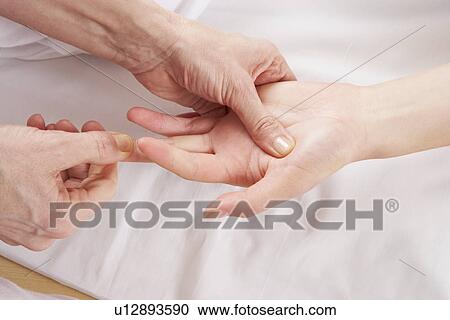 Stock Image - Detail hand reflexology massage. Fotosearch