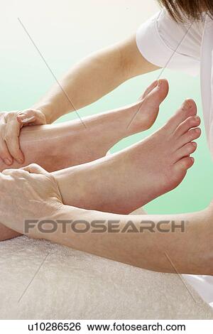Stock Photograph - Detail woman having foot massage. Fotosearch