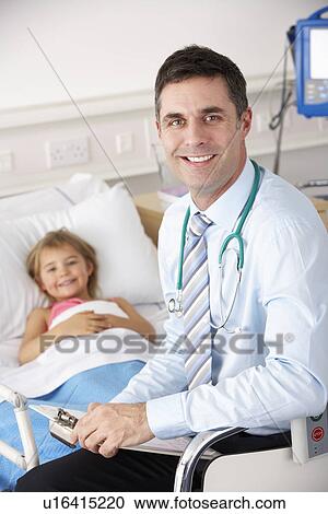 Stock Image - Doctor with child patient in UK Accident and Emergency. Fotosearch