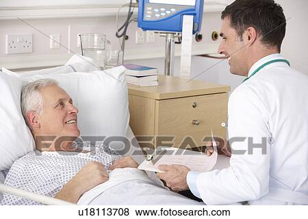 Stock Photo - Doctor with senior male patient on USA Hospital ward. Fotosearch
