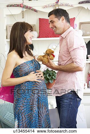 Picture - Expectant couple out shopping. Fotosearch