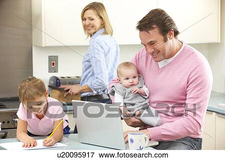 Family Busy Together In Kitchen Stock Photo 