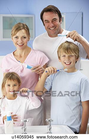 Stock Photography - Family cleaning teeth together in bathroom. Fotosearch