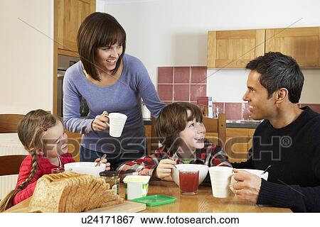 Family Eating Breakfast Together In Kitchen View Large Photo Image Stock Photo - Family Eating Breakfast Together In Kitchen. Fotosearch