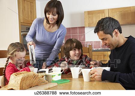 Family Eating Breakfast Together In Kitchen View Large Photo Image Stock Photo - Family Eating Breakfast Together In Kitchen. Fotosearch