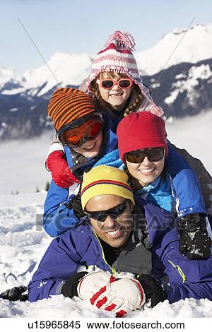 Family Having Fun On Ski Holiday In Mountains View Large Photo Image Stock Photography - Family Having Fun On Ski Holiday In Mountains. Fotosearch