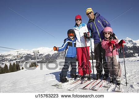 Stock Image - Family On Ski Holiday In Mountains. Fotosearch