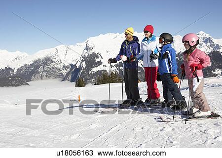 Stock Image - Family On Ski Holiday In Mountains. Fotosearch